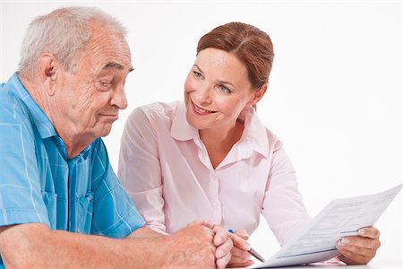 smiling senior people talking family - Man and Woman Discussing Paperwork Stock Photo - Premium Royalty-Free, Code: 600-03893404