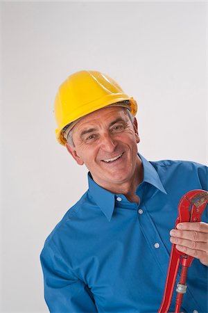 Portrait of Man wearing Hardhat and holding Wrench Stock Photo - Premium Royalty-Free, Code: 600-03907109