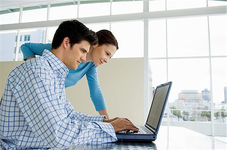 Couple using laptop Stock Photo - Premium Royalty-Free, Code: 614-05399685