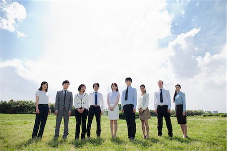 Businesspeople in a row in field Stock Photo - Premium Royalty-Free, Code: 614-05399775