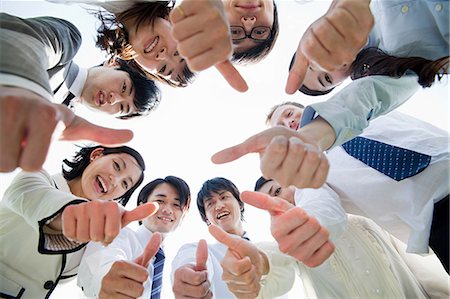 Businesspeople in a circle with thumbs up Stock Photo - Premium Royalty-Free, Code: 614-05399782