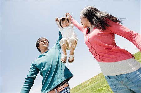 people on swing - Parents lifting son mid air Stock Photo - Premium Royalty-Free, Code: 614-05399828