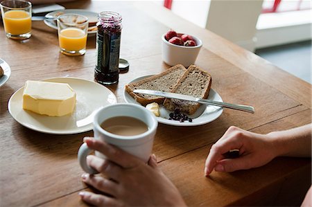 person cupping hands - Woman having breakfast, high angle Stock Photo - Premium Royalty-Free, Code: 614-05556656