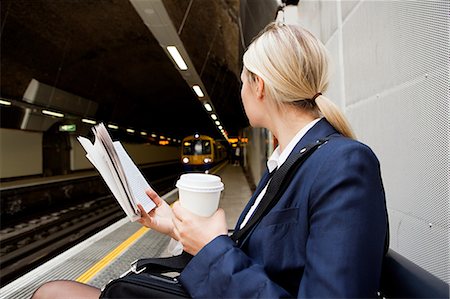 Businesswoman waiting for London Overground train Stock Photo - Premium Royalty-Free, Code: 614-05556705