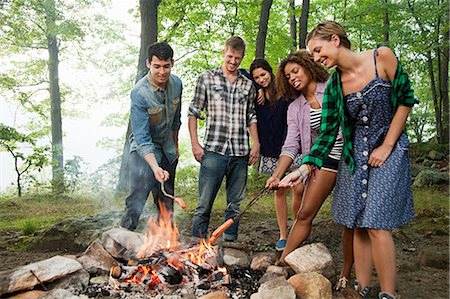 simsearch:625-01251856,k - Friends cooking over campfire in forest Stock Photo - Premium Royalty-Free, Code: 614-05556844