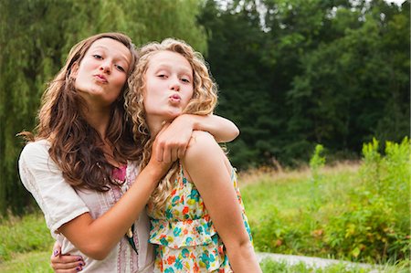 Teenage girls fooling around and puckering lips Stock Photo - Premium Royalty-Free, Code: 614-05556995