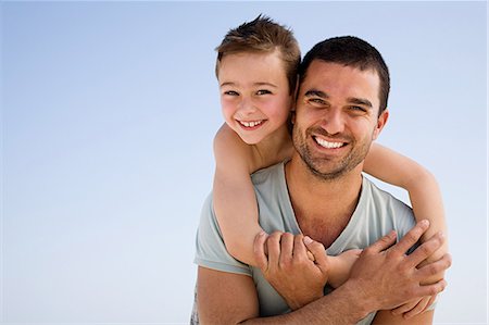 Father and son embracing Stock Photo - Premium Royalty-Free, Code: 614-05557168