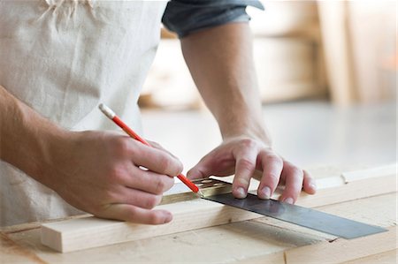 Carpenter using mitre in workshop Stock Photo - Premium Royalty-Free, Code: 614-05557234