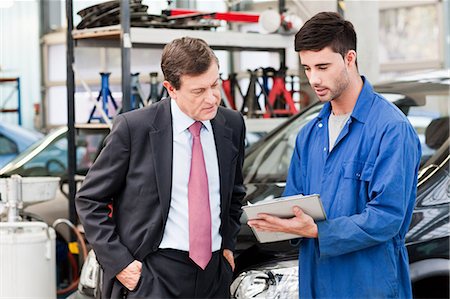 simsearch:614-05557261,k - Businessman with car mechanics in repair garage Stock Photo - Premium Royalty-Free, Code: 614-05557266