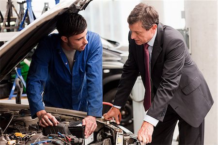 simsearch:614-05557261,k - Businessman looking at car engine with mechanic Stock Photo - Premium Royalty-Free, Code: 614-05557269