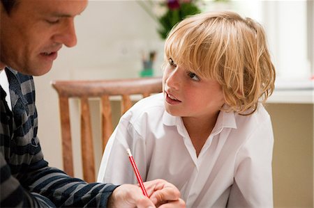 Father helping son with homework Stock Photo - Premium Royalty-Free, Code: 614-05650648