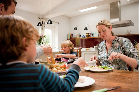 family and meal - Family sitting down and eating a healthy meal together Stock Photo - Premium Royalty-Free, Code: 614-05650641