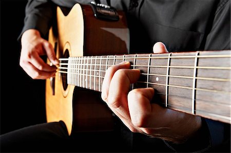 Close up of person playing classical guitar Fotografie stock - Premium Royalty-Free, Codice: 614-05650715