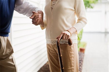 Senior couple standing with walking stick Stock Photo - Premium Royalty-Free, Code: 614-05650728