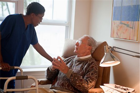 Nurse looking after senior man at home Stock Photo - Premium Royalty-Free, Code: 614-05650729