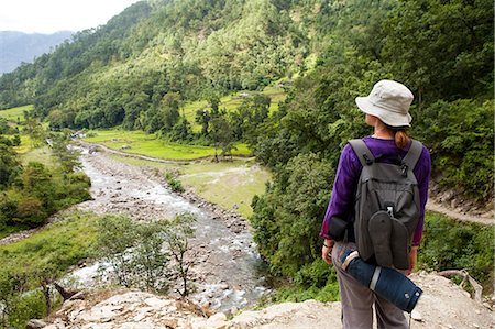 Tourist looking over valley, Nepal Stock Photo - Premium Royalty-Free, Code: 614-05650854