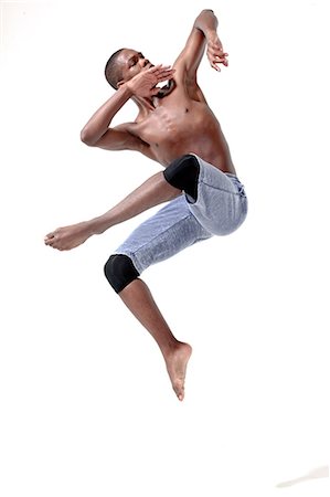 dancing on white background - Young man in mid air Foto de stock - Sin royalties Premium, Código: 614-05650903