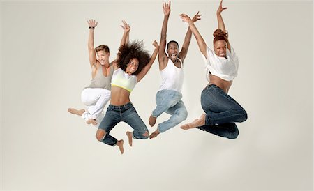 dancing white background - Four young adults jumping in the air with joy Stock Photo - Premium Royalty-Free, Code: 614-05650916