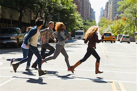 people running in a city - Five friends running through city street Stock Photo - Premium Royalty-Free, Code: 614-05650936