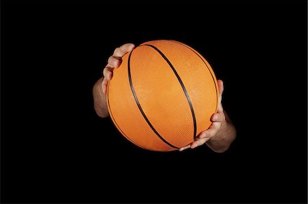 Close up of basket ball being held Stock Photo - Premium Royalty-Free, Code: 614-05662160