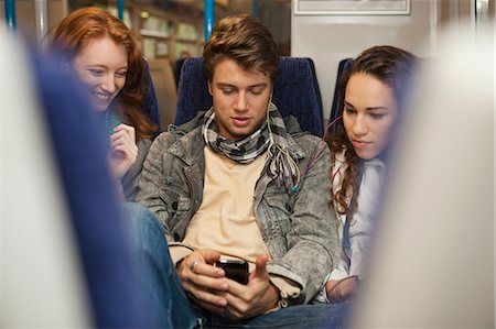people in a locomotive - Three young friends travelling on train listening to music Stock Photo - Premium Royalty-Free, Code: 614-05662217