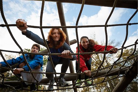 Young friends climbing assault course equipment Stock Photo - Premium Royalty-Free, Code: 614-05662238