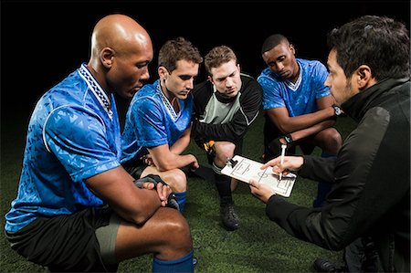 football practice - Soccer team planning game with coach Stock Photo - Premium Royalty-Free, Code: 614-05662293