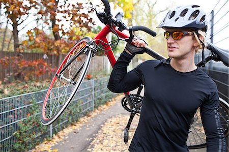 Cyclist carrying bike Stock Photo - Premium Royalty-Free, Code: 614-05792076