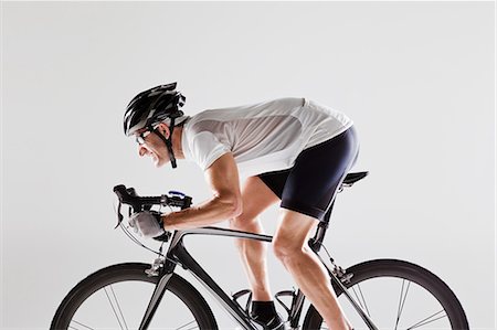 side view white background - Determined male cyclist Stock Photo - Premium Royalty-Free, Code: 614-05792261