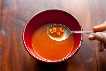 pollice - Woman holding spoonful of soup with letters LOVE Fotografie stock - Premium Royalty-Free, Codice: 614-05792282