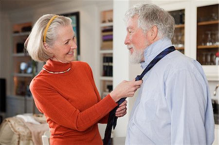 Wife tying tie for husband Stock Photo - Premium Royalty-Free, Code: 614-05792326