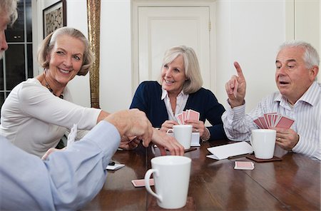 playing cards table - Senior friends playing cards Stock Photo - Premium Royalty-Free, Code: 614-05792349