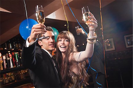 party latino - Young couple celebrating with champagne Stock Photo - Premium Royalty-Free, Code: 614-05792423