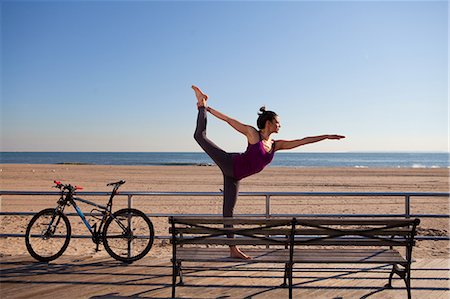 Woman in yoga pose on promenade Stock Photo - Premium Royalty-Free, Code: 614-05792458
