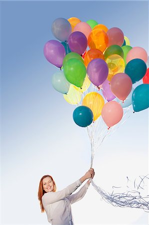 string (not clothing, packaging or instruments) - Young woman outdoors with balloons Foto de stock - Sin royalties Premium, Código: 614-05792515