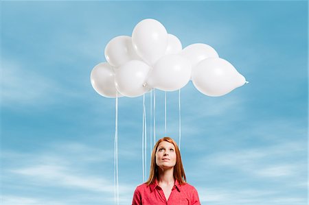 float - Young woman looking at thought bubble made of balloons Stock Photo - Premium Royalty-Free, Code: 614-05792521