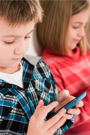 Children using smartphones Stock Photo - Premium Royalty-Free, Code: 614-05818941