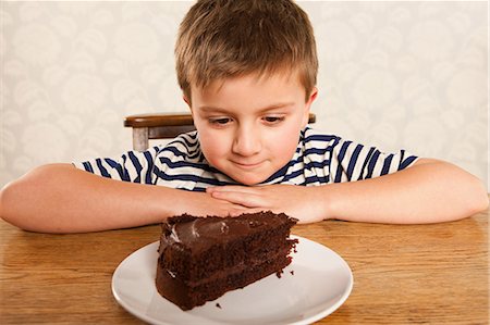 slices of cake - Boy looking at slice of chocolate cake Stock Photo - Premium Royalty-Free, Code: 614-05818950