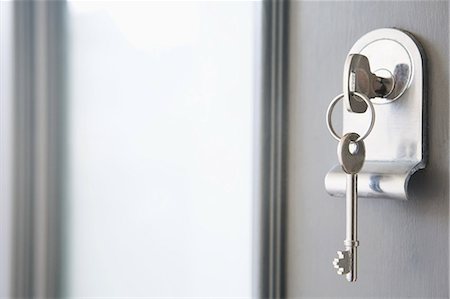 sold house - Close up of key in a front door Stock Photo - Premium Royalty-Free, Code: 614-05818999