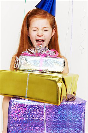 Screaming girl with stack of birthday gifts Fotografie stock - Premium Royalty-Free, Codice: 614-05819070