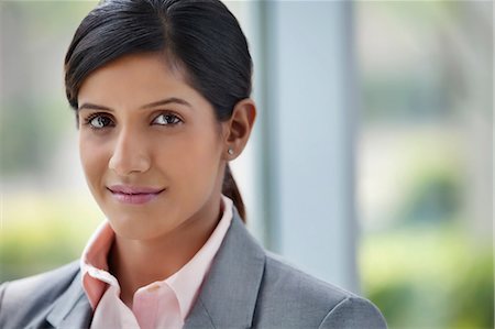 portrait of a woman smiling indian - Portrait of a businesswoman Stock Photo - Premium Royalty-Free, Code: 614-05955333