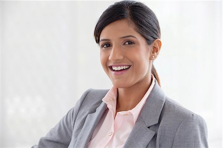 Portrait of a businesswoman smiling Stock Photo - Premium Royalty-Free, Code: 614-05955344