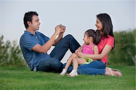 family happiness grass - Man taking a photograph of his family Stock Photo - Premium Royalty-Free, Code: 614-05955380