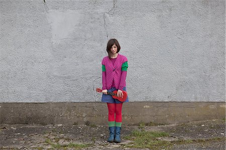 fashion light - Young woman standing with ukulele Stock Photo - Premium Royalty-Free, Code: 614-05955472