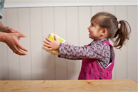 Little girl giving a gift to adult Stock Photo - Premium Royalty-Free, Code: 614-05955605