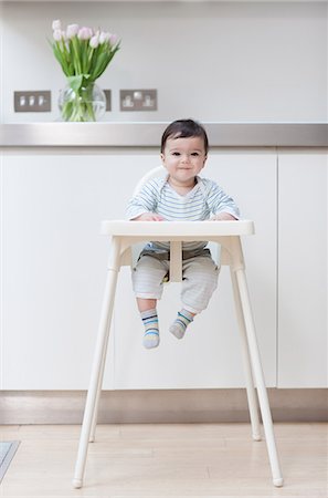 Baby boy in his high chair Stock Photo - Premium Royalty-Free, Code: 614-05955626