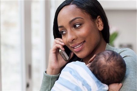 simsearch:614-06537411,k - Mother on cellphone, holding baby son Stock Photo - Premium Royalty-Free, Code: 614-05955646