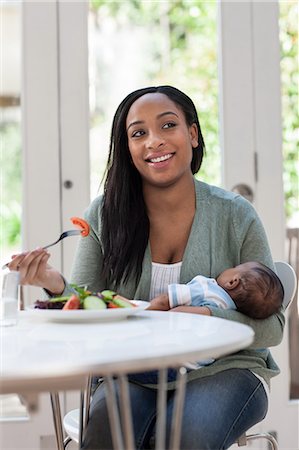 Mother holding baby son and having lunch Stock Photo - Premium Royalty-Free, Code: 614-05955641