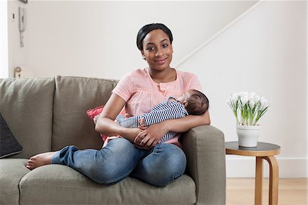 simsearch:6122-07698015,k - Young woman on sofa with baby son Stock Photo - Premium Royalty-Free, Code: 614-05955656