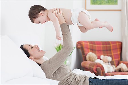 Mother lifting up baby boy Stock Photo - Premium Royalty-Free, Code: 614-05955668